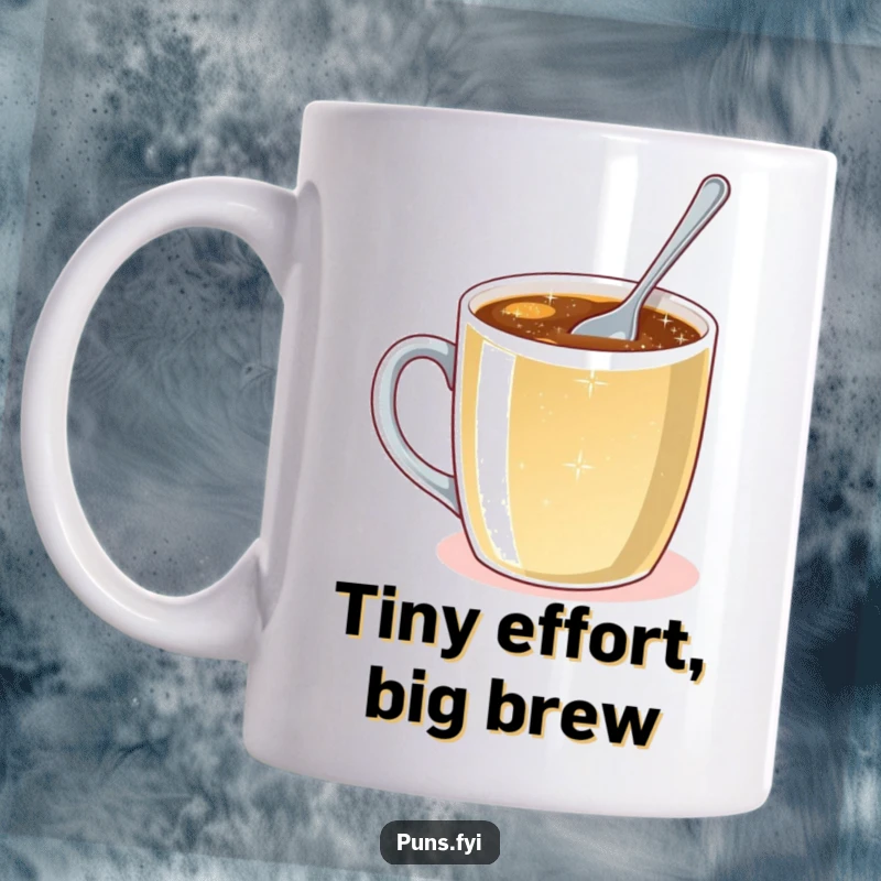 Funny mug depicting a minuscule spoon striving to stir a giant coffee mug brimming with effervescent, sparkling liquid.