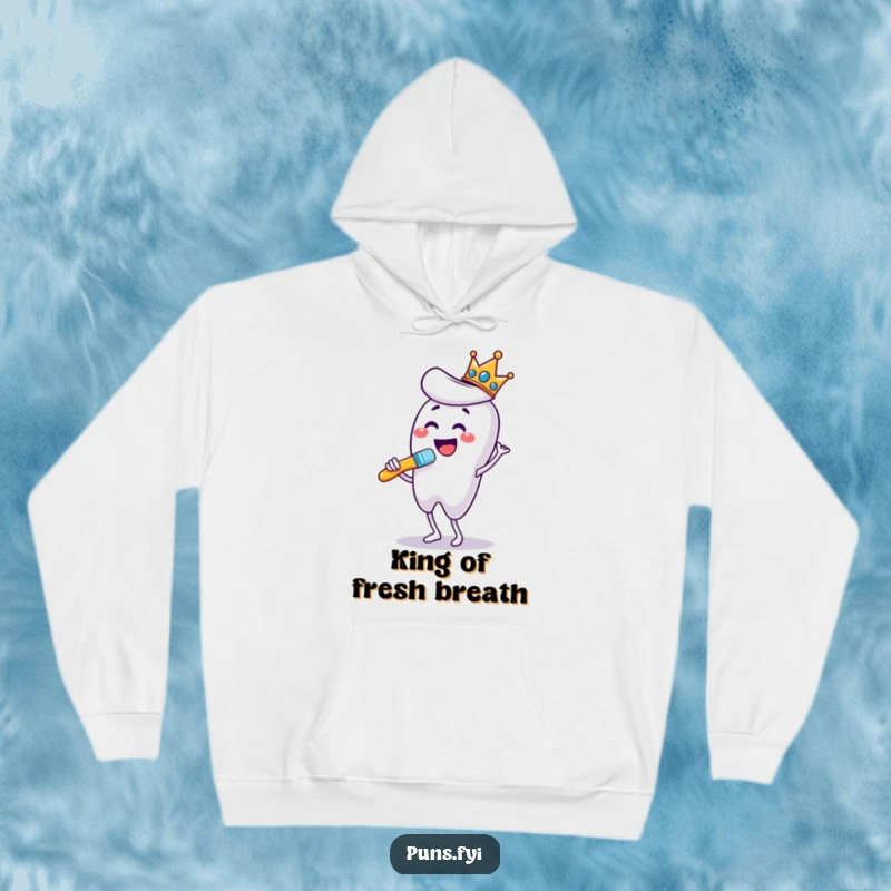 Funny hoodie featuring a crowned toothbrush dancing enthusiastically while brushing a giant tooth, bringing cozy dental humor.
