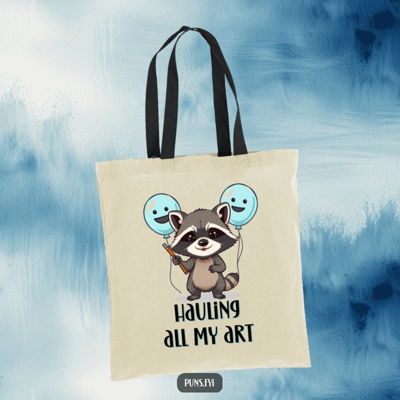 Funny tote bag showing a determined raccoon character painting funny faces on balloons, perfect for carrying party supplies.